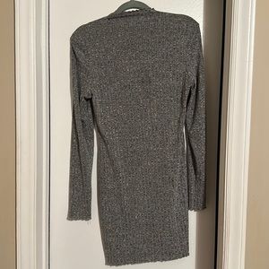 Large grey spandex mid length hem with long sleeves with lettuce cut trim.